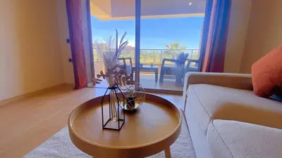 a living room with a couch and a coffee table at Marrakech golf city prestigia in Marrakech