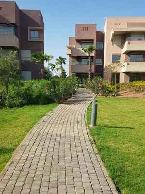 a brick path in front of some buildings at Marrakech golf city prestigia in Marrakech