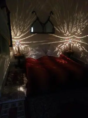 a bedroom with a bed with lights on it at Riad Chennaoui in Marrakech
