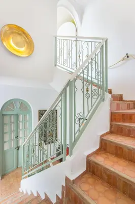 a staircase in a home with a green and white stair case at Riad Helen in Marrakech