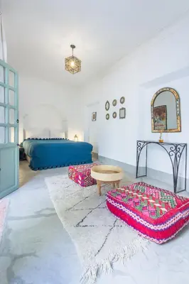 a living room with a bed and a rug at Riad Helen in Marrakech