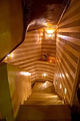 a wooden staircase with lights in a room at Dar Anika in Marrakech