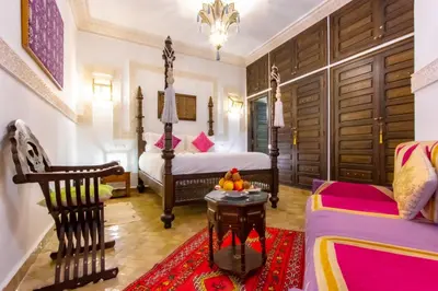 a bedroom with a bed and a couch at Dar Anika in Marrakech