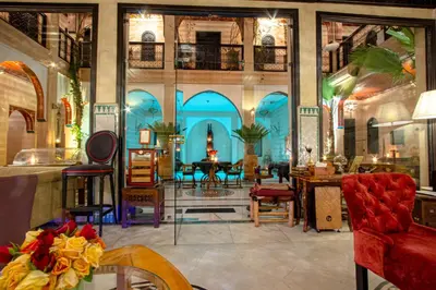 a room with chairs and a table in a building at Dar Anika in Marrakech