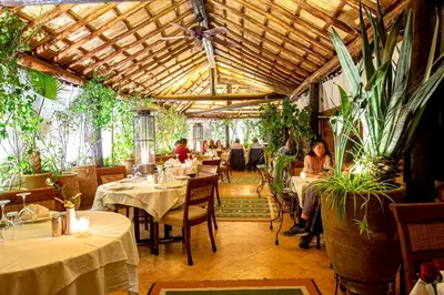 a restaurant with tables and people sitting at tables at Dar Anika in Marrakech