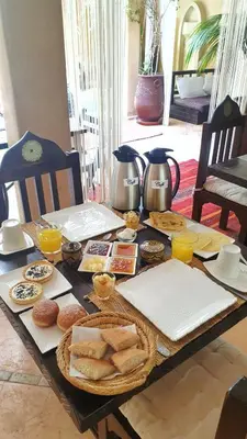 a wooden table with food and drinks on it at Riad Karmanda in Marrakech