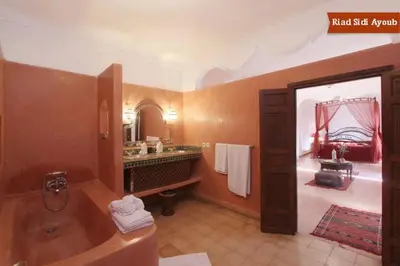 a large bathroom with a tub and a sink at Riad Sidi Ayoub in Marrakech