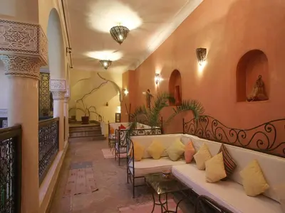 a living room with a couch and some chairs at Riad Sidi Ayoub in Marrakech