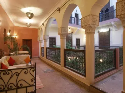 a porch with a couch and a balcony at Riad Sidi Ayoub in Marrakech