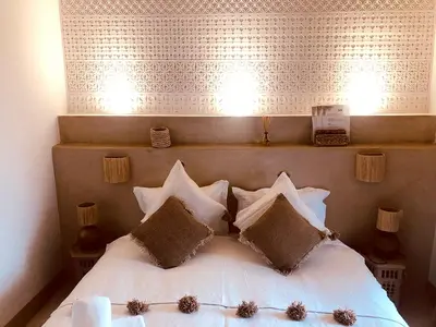 a bedroom with a white bed with four pillows at Riad Bamboo Suites & Spa in Marrakech