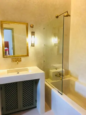 a bathroom with a sink and a shower and a tub at Riad Alia in Marrakech