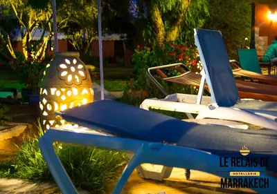 a group of boats parked in a yard at night at Le Relais De Marrakech in Marrakech