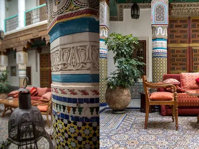a room with a pillar with a table and chairs at Riad Palais Sebban in Marrakech