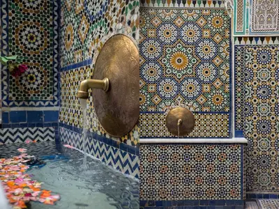 a bathroom with a tub with a water fountain at Riad Palais Sebban in Marrakech