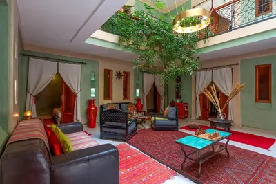 a living room with a couch and a table at Riad l'Heure d'Eté in Marrakech