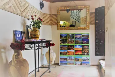 a room with a mirror and a table with flowers at Les Jardins Mandaline in Marrakech