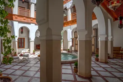 a courtyard with a pool in a building at Riad Safran et Cannelle & Spa in Marrakech
