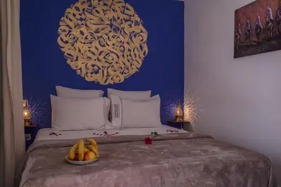 a bedroom with a bed with a bowl of fruit on it at Riad Safran et Cannelle & Spa in Marrakech