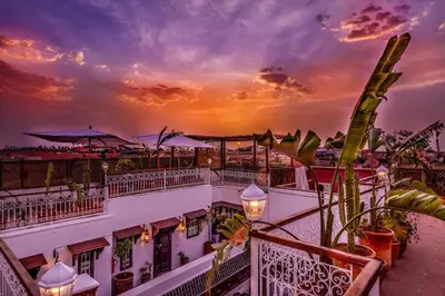 a view of a building with a sunset in the background at Riad Safran et Cannelle & Spa in Marrakech