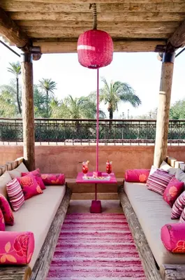 a room with pink and white pillows and a table at Tigmiza Boutique Hotel & Spa in Marrakech