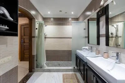 a bathroom with two sinks and a shower at Riad Ushuaia - Centre Marrakech in Marrakech