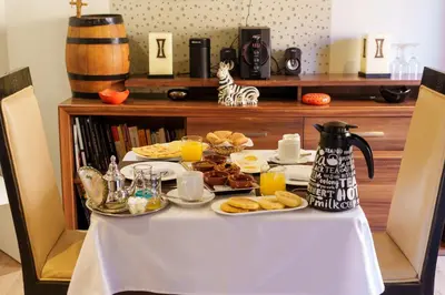 a table with breakfast foods and orange juice on it at Riad Ushuaia - Centre Marrakech in Marrakech