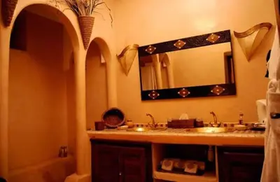 a bathroom with a sink and a mirror at Riad D'Airain in Marrakech