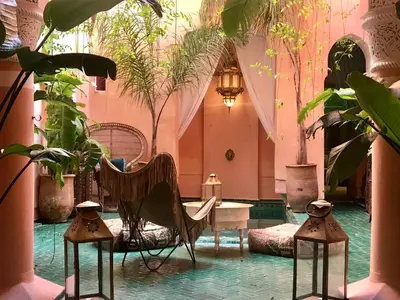a room with potted plants and a table and chairs at The Bohemian Jungle in Marrakech