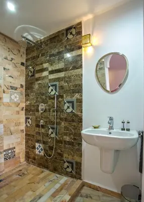 a bathroom with a sink and a shower at Riad Leila Marrakech in Marrakech