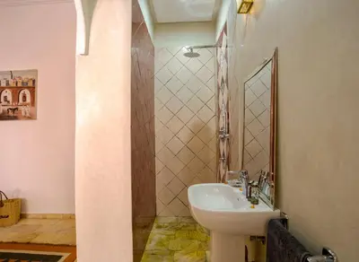 a bathroom with a sink and a mirror at Riad Leila Marrakech in Marrakech