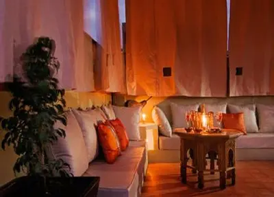 a living room with a couch and a table at Riad Chayma Marrakech in Marrakech