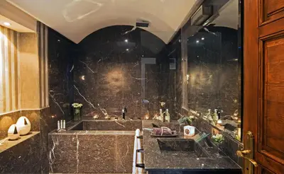 a bathroom with a large shower and a sink at Riad Chayma Marrakech in Marrakech