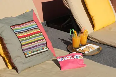 a tent with a blanket and a plate of food and drinks at Riad Chergui in Marrakech