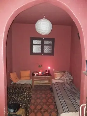 a living room with a couch and a table at Riad Hayed in Marrakech