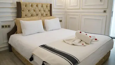 a large white bed with two towels on it at Riad Les Oliviers & Spa in Marrakech