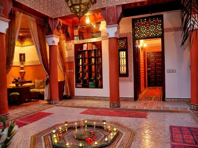 a living room with a room with a table and a roomasteryasteryasteryastery at Riad Lila in Marrakech