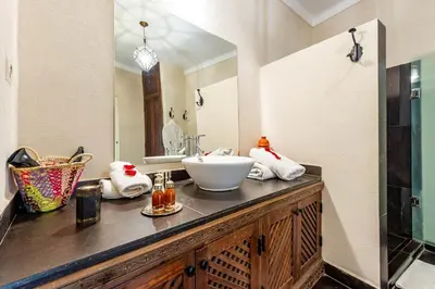 a bathroom with a sink and a mirror at Riad L'orange Bleue in Marrakech