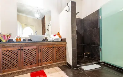 a bathroom with a sink and a shower at Riad L'orange Bleue in Marrakech