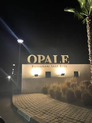a building with a large sign on it at night at APPARTEMENT Golf Marrakech prestigia in Marrakech