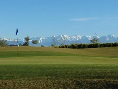 a golf course with a flag on a green at APPARTEMENT Golf Marrakech prestigia in Marrakech
