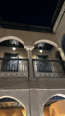 a building with a balcony with lights on it at Riad Jonan & Spa in Marrakech