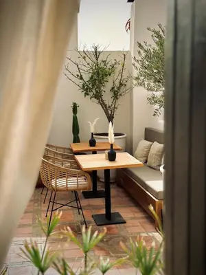 a living room with a table and a couch at Riad Jonan & Spa in Marrakech