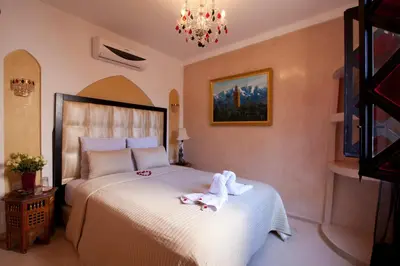 a bedroom with a bed with towels on it at Riad Le Rubis in Marrakech