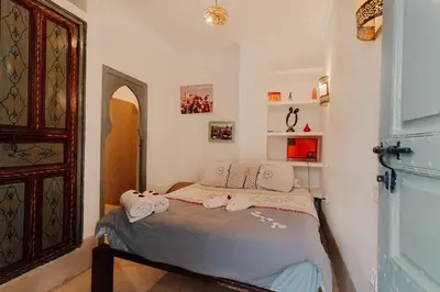 a bedroom with a bed with towels on it at Riad Manaoui in Marrakech