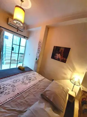 a bedroom with a large bed and a window at Riad Manaoui in Marrakech