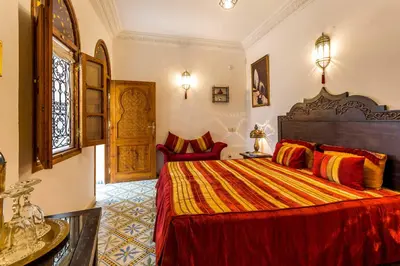 a bedroom with a large bed in a room at Riad Mouna in Marrakech