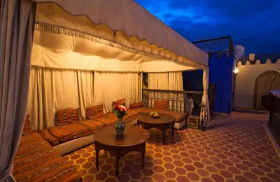 a living room with a couch and a table at Riad Lakhdar in Marrakech