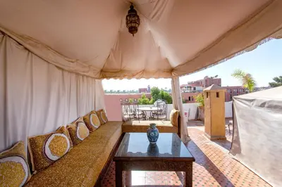 a living room with a couch and a table at Riad Lakhdar in Marrakech