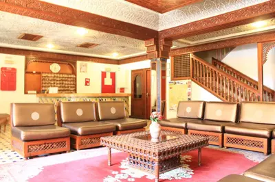 a living room with leather couches and a coffee table at El Hamra Hotel in Marrakech