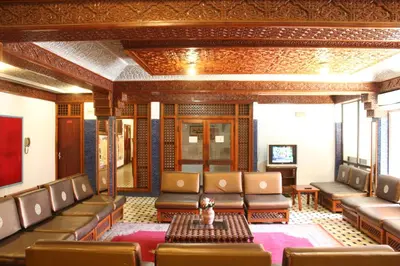 a waiting room with leather chairs and a table at El Hamra Hotel in Marrakech